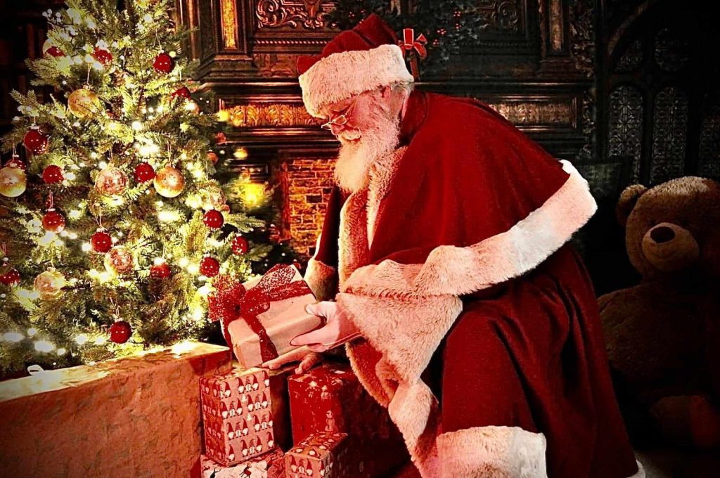 Santa leaving presents under the tree